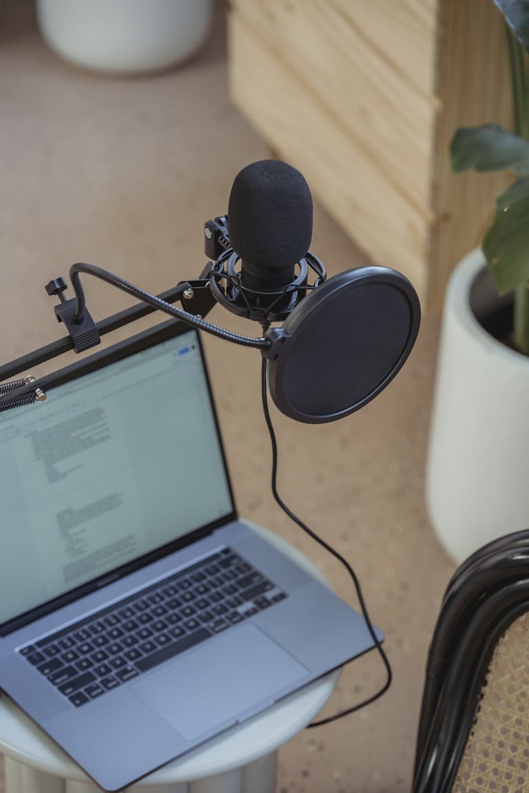 Microphone on tripod attached to laptop in studio